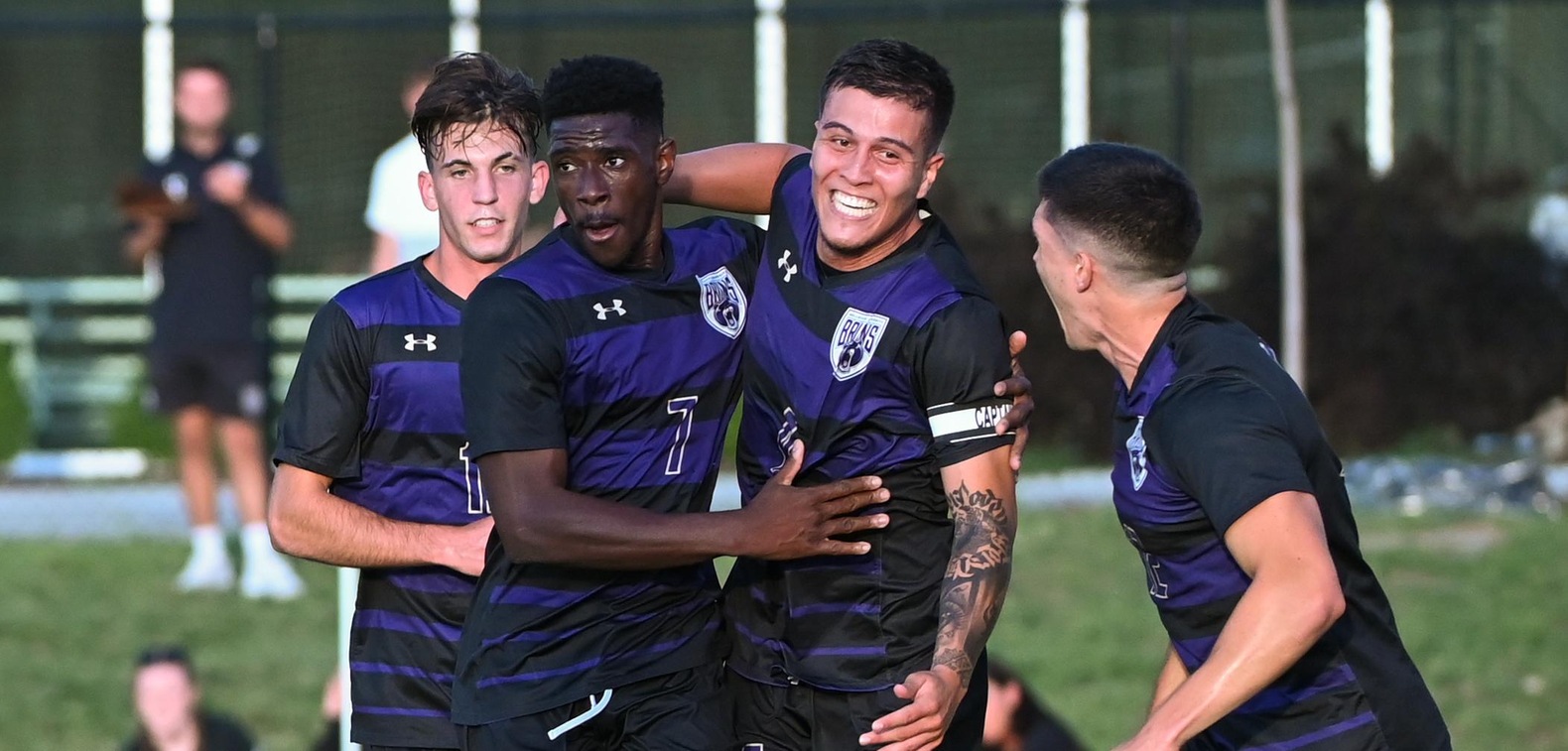 Sebastian Zapata is congratulated by teammates after scoring BU's first goal of the year in the opening minutes of Thursday's game against Doane.